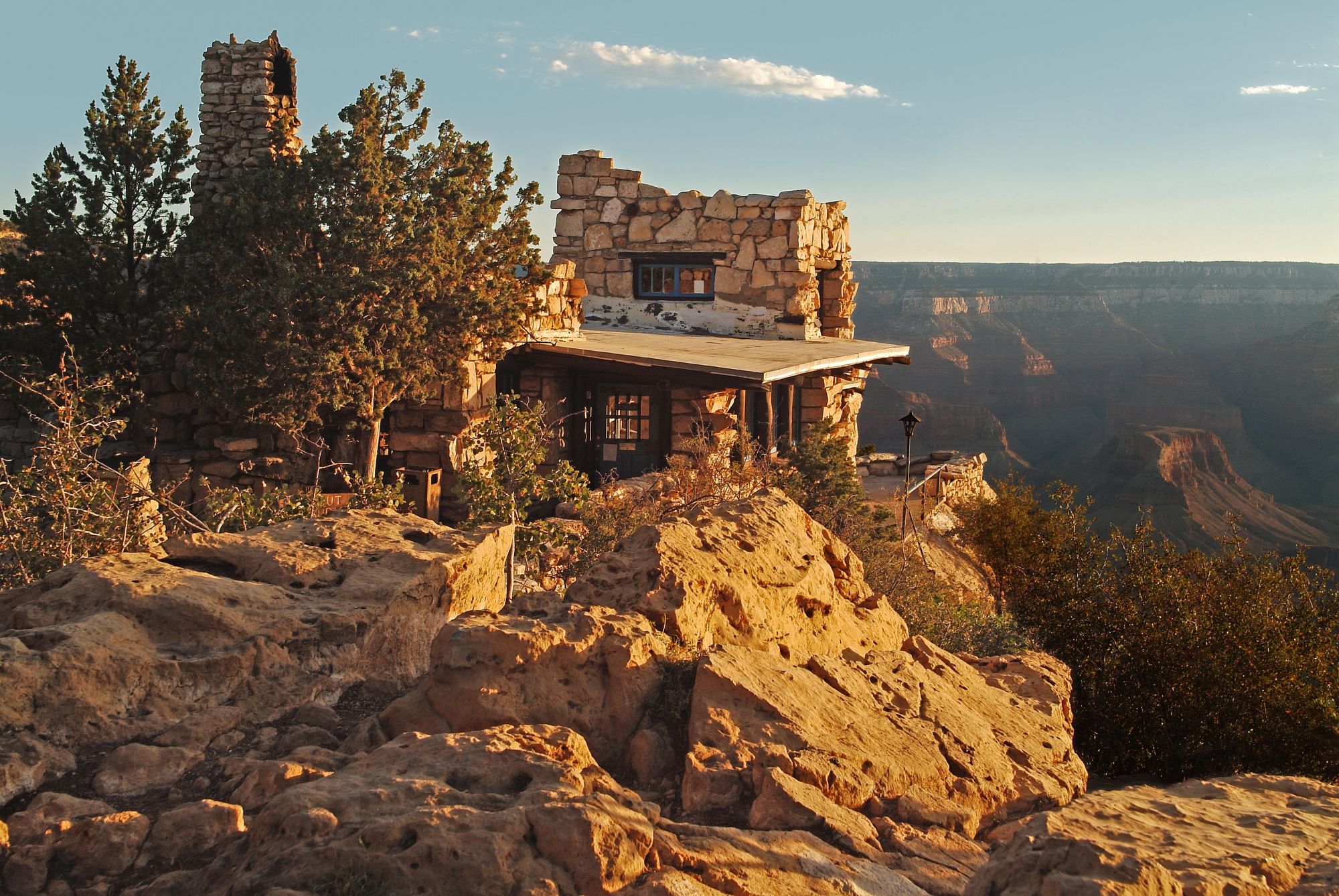 A rustic lookout made of stone sits on the edge of the Grand Canyon.