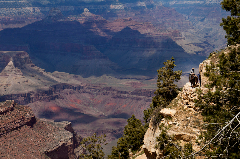A dark shadow sweeps across the Grand Canyon.